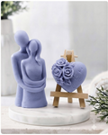 This gift set features a stunning soap sculpture of a man gently embracing a woman alongside a charming rose-adorned heart soap, stamped with the heartfelt message "I LOVE U".