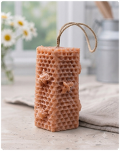 Load image into Gallery viewer, A tall, rectangular handmade vegan soap with a detailed honeycomb texture on all sides and small embossed bees, featuring a natural twine hanging rope, displayed upright on a light wooden surface.
