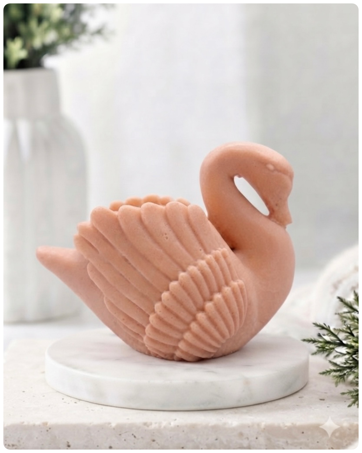 handmade vegan soap, sculpted into the shape of a graceful swan with detailed feathering on its wings and a curved neck, displayed on a light wooden surface in a bright farmhouse setting.