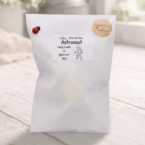 White product packaging with branding on a light wooden surface.