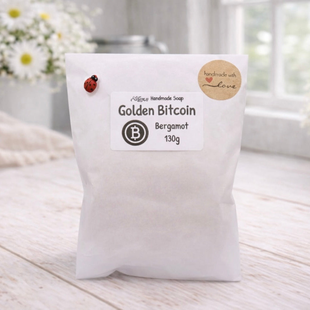 White soap bag with 'Golden Bitcoin' branding on a light wooden surface.
