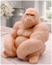 Load image into Gallery viewer, A large highly detailed handmade vegan soap in the shape of a sitting gorilla with realistic fur and muscle textures, displayed on a light wooden surface.
