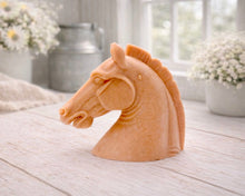 Load image into Gallery viewer, horse head vegan soap gift sculpture on a light wooden surface with blurred floral and candle background
