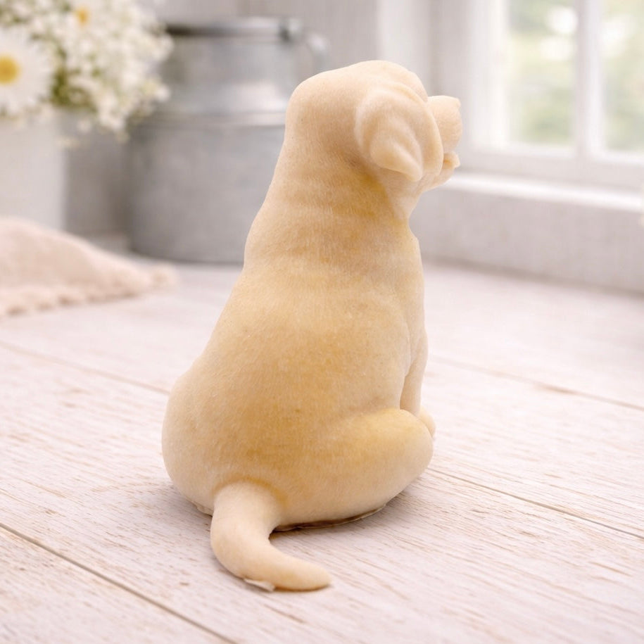 handmade vegan soap in the shape of a happy sitting Labrador retriever puppy sculpture with its tongue out, displayed in a bright farmhouse decor setting.
