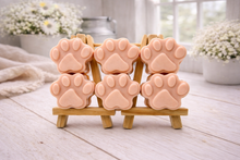 Load image into Gallery viewer, Set of pink paw-shaped vegan hand soaps on a wooden stand with a blurred indoor background.
