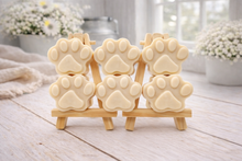Load image into Gallery viewer, Set of dog paw-shaped vegan soaps on a wooden stand with a light background
