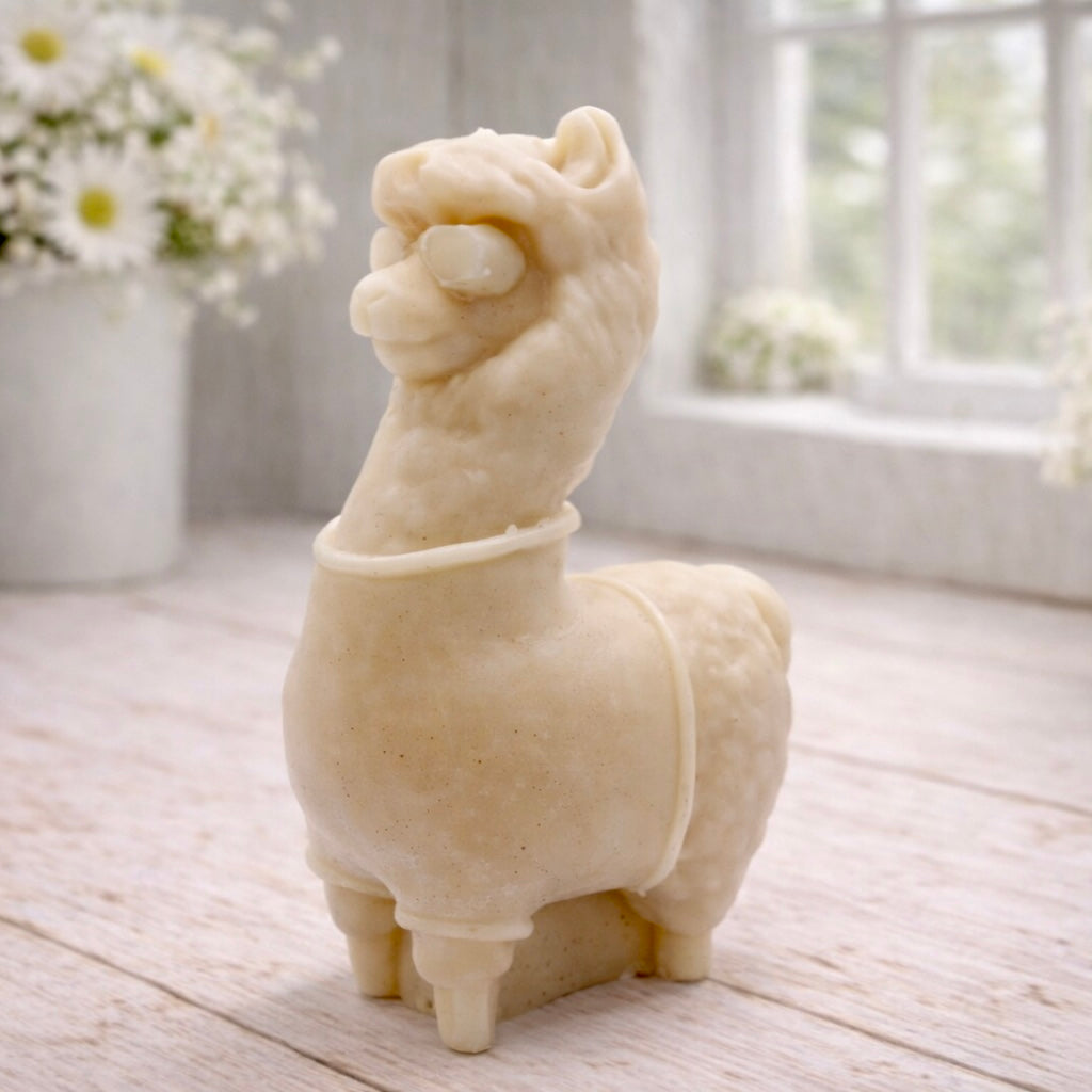 handmade vegan soap in the shape of a realistic standing alpaca or llama sculpture, featuring a smooth body with detailed fur texture on the head and neck, displayed in a bright farmhouse decor setting.