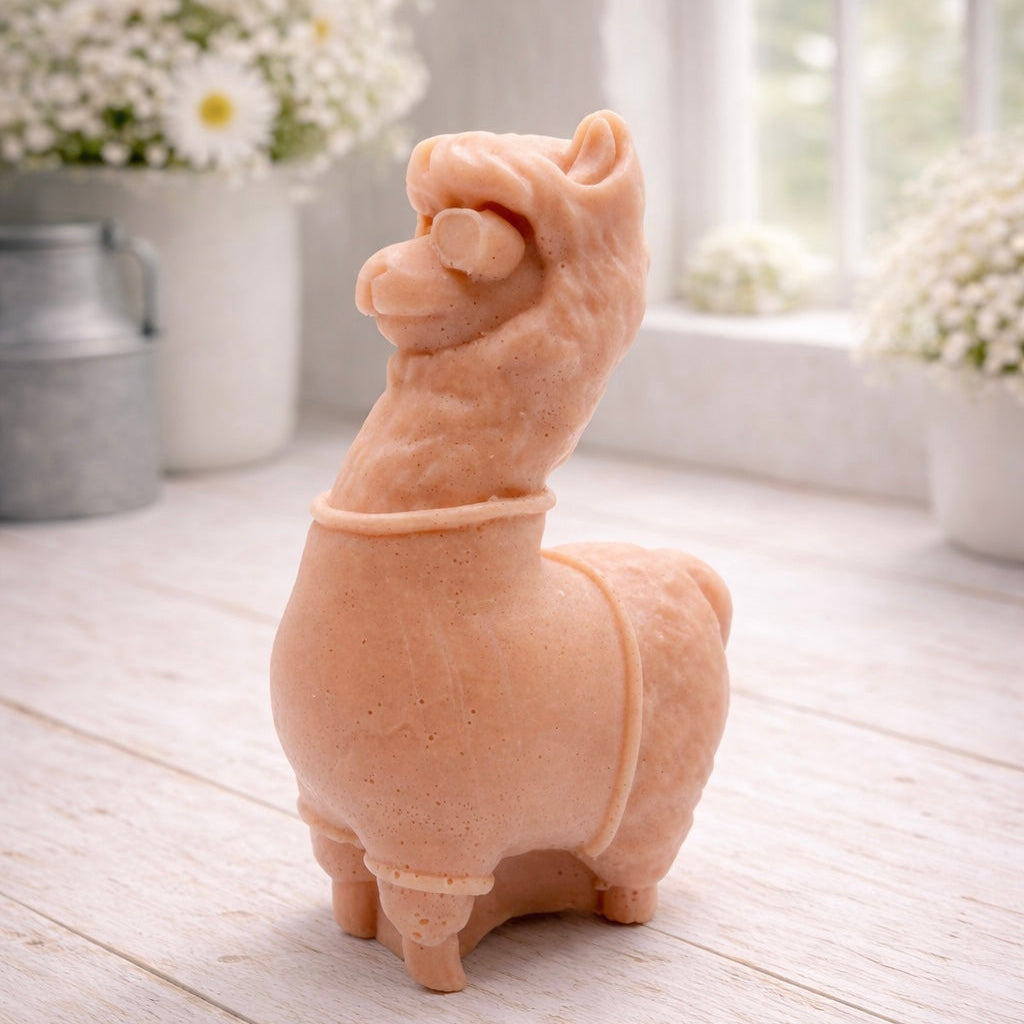handmade vegan soap in the shape of a realistic standing alpaca or llama sculpture, featuring a smooth body with detailed fur texture on the head and neck, displayed in a bright farmhouse decor setting.
