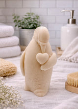 Load image into Gallery viewer, handmade vegan soap in the shape of a realistic penguin sculpture holding a small heart to its chest,

