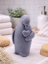 Load image into Gallery viewer, handmade vegan soap in the shape of a realistic penguin sculpture holding a small heart to its chest,
