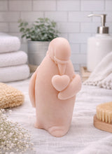 Load image into Gallery viewer, handmade vegan soap in the shape of a realistic penguin sculpture holding a small heart to its chest,
