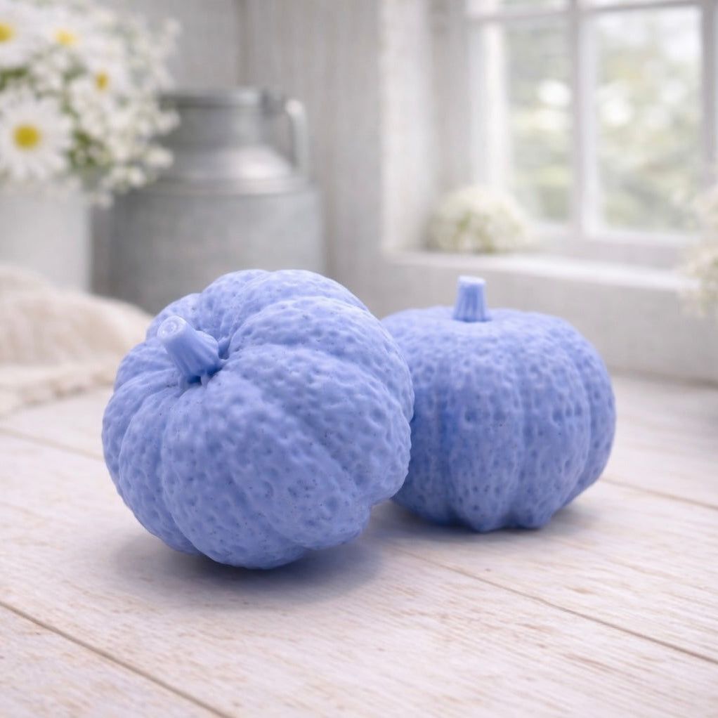 handmade vegan soaps in the shape of realistic chunky pumpkins, featuring detailed bumpy skin texture and stems, displayed on a rustic white wooden surface in a bright farmhouse decor setting.