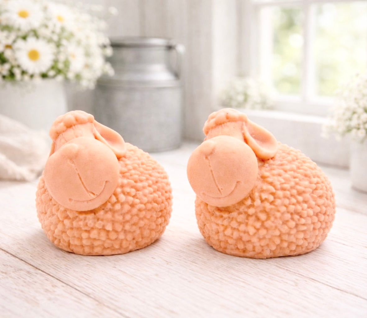 Two handmade vegan soap gift set featuring two fluffy spring lambs with detailed wool texture, displayed on a weathered white wooden surface in a bright farmhouse decor room