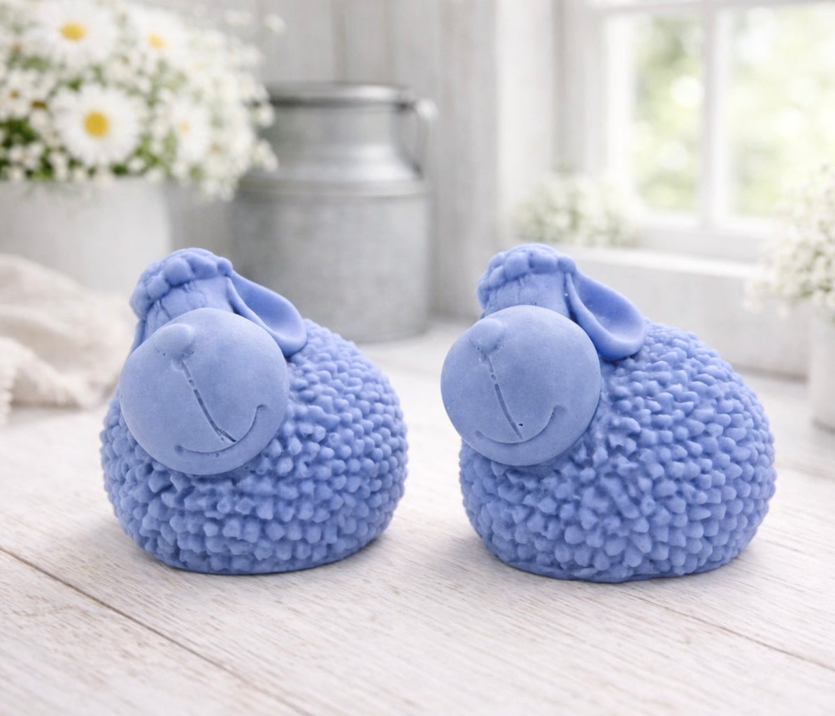 Two handmade vegan soap gift set featuring two fluffy spring lambs with detailed wool texture, displayed on a weathered white wooden surface in a bright farmhouse decor room