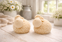 Load image into Gallery viewer, Two handmade vegan soaps in the shape of fluffy spring lambs with detailed wool texture, displayed on a weathered white wooden surface in a bright farmhouse decor room
