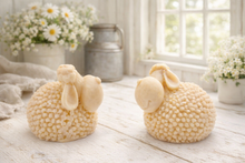 Load image into Gallery viewer, Two handmade vegan soaps in the shape of fluffy spring lambs with detailed wool texture, displayed on a weathered white wooden surface in a bright farmhouse decor room
