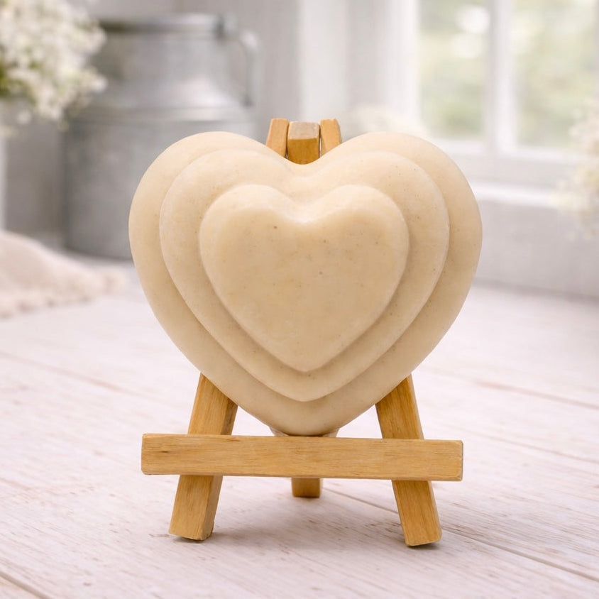 handmade vegan soap gift featuring a triple-tiered heart relief design, displayed on a wooden easel against a rustic farmhouse decor background with lavender.