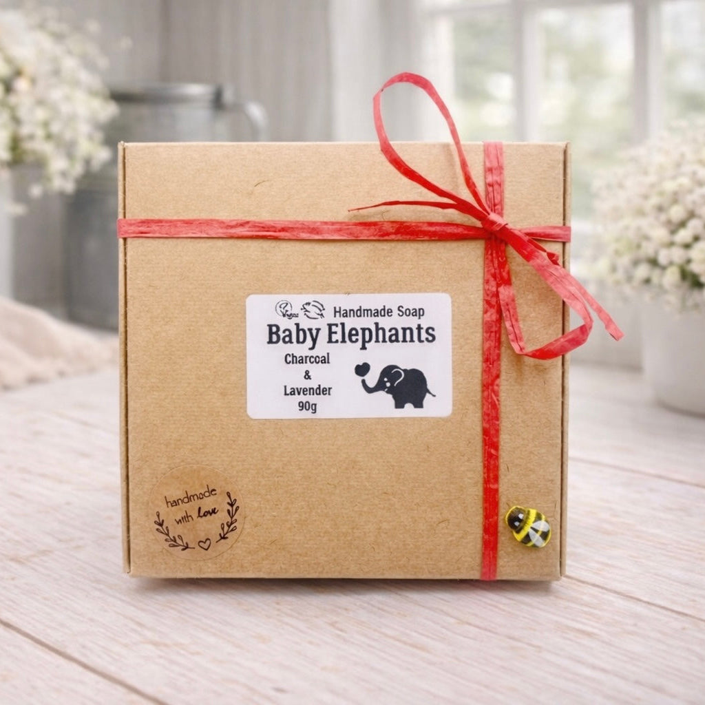 Handmade soap packaging with 'Baby Elephants' label on a wooden surface