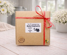 Load image into Gallery viewer, Handmade soap packaging with 'Baby Elephants' label on a wooden surface
