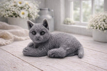 Load image into Gallery viewer, A highly detailed handmade vegan soap sculpted in the shape of a sitting cat with its tail curled around its paws, featuring realistic fur texture and a sweet facial expression, displayed on a light wooden surface.
