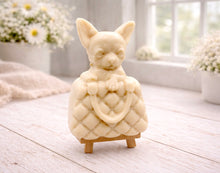 Load image into Gallery viewer, A highly detailed handmade vegan soap in a speckled grey marble finish, sculpted as a small chihuahua puppy with large ears peeking out from inside a quilted designer-style handbag, displayed on a miniature wooden easel.
