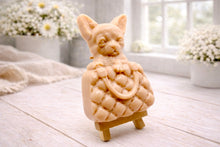 Load image into Gallery viewer, A highly detailed handmade vegan soap in a speckled grey marble finish, sculpted as a small chihuahua puppy with large ears peeking out from inside a quilted designer-style handbag, displayed on a miniature wooden easel.
