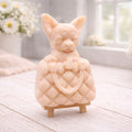 A highly detailed handmade vegan soap in a speckled grey marble finish, sculpted as a small chihuahua puppy with large ears peeking out from inside a quilted designer-style handbag, displayed on a miniature wooden easel.