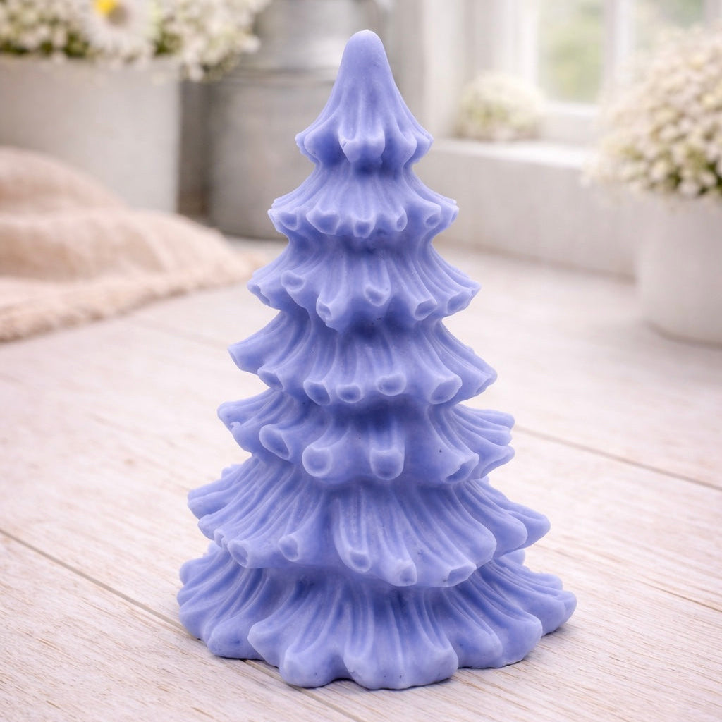 vegan soap sculpted into a realistic evergreen Christmas tree with multiple layers of textured, needle-like branches, with a subtle snow-dusted effect.
