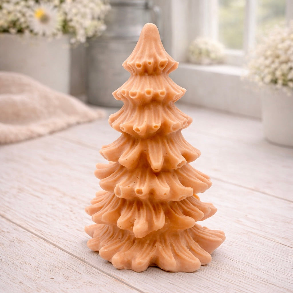 vegan soap sculpted into a realistic evergreen Christmas tree with multiple layers of textured, needle-like branches, with a subtle snow-dusted effect.