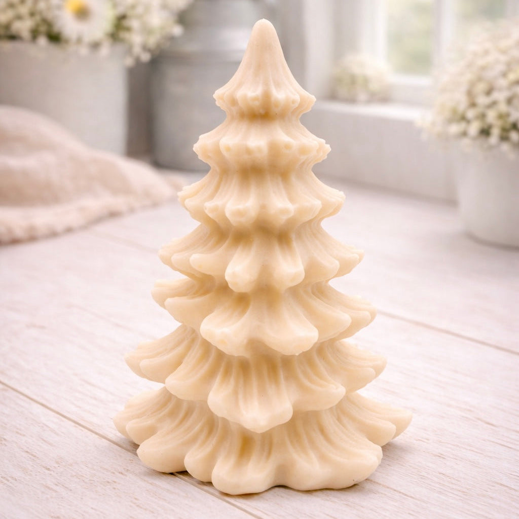 vegan soap sculpted into a realistic evergreen Christmas tree with multiple layers of textured, needle-like branches, with a subtle snow-dusted effect.