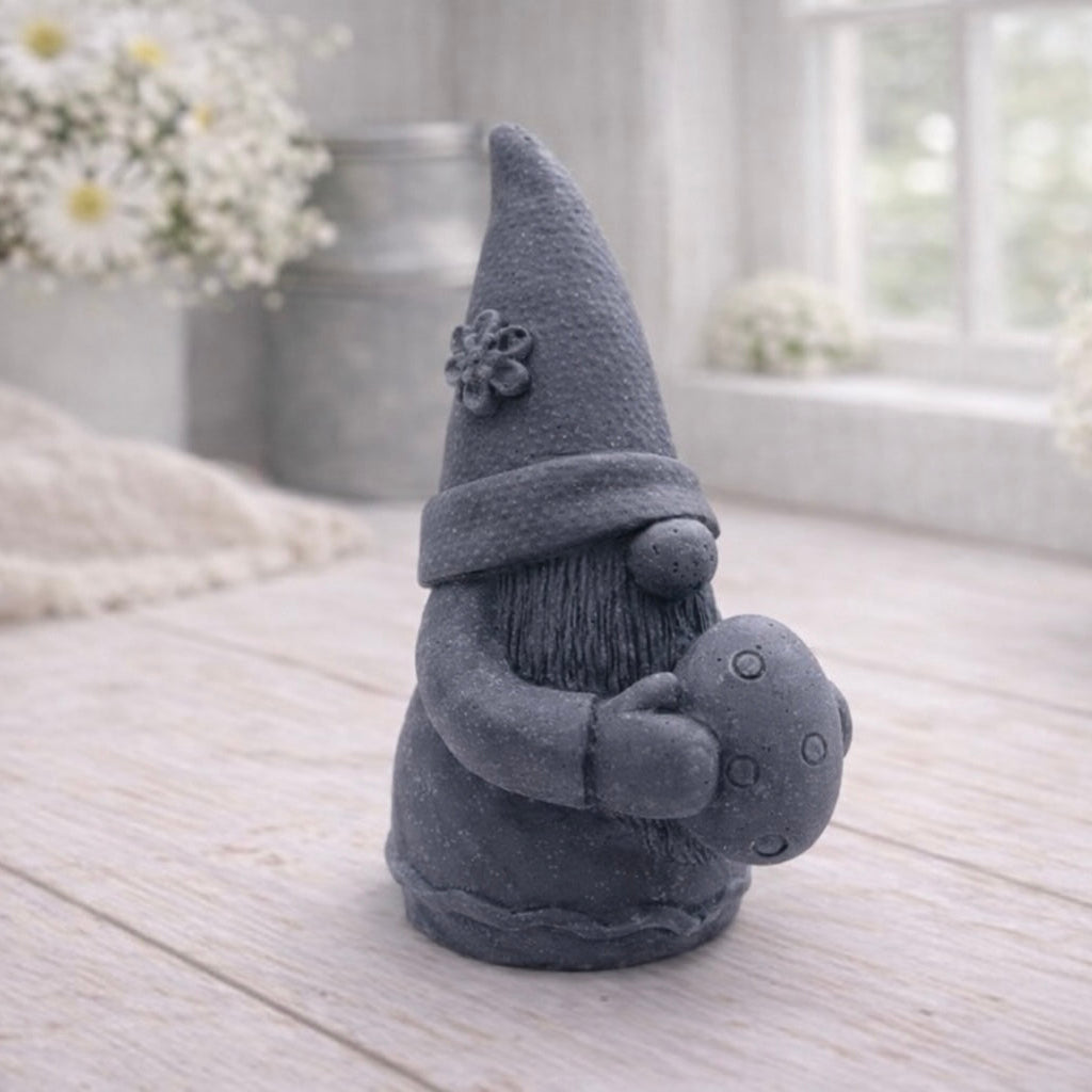 A detailed handmade vegan soap gift,  sculpted as a whimsical Easter gnome (gonk) wearing a tall pointed hat with a flower detail, holding a large patterned Easter egg.