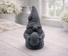 Load image into Gallery viewer, A detailed handmade vegan soap gift,  sculpted as a whimsical Easter gnome (gonk) wearing a tall pointed hat with a flower detail, holding a large patterned Easter egg.
