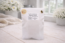 Load image into Gallery viewer, White package with branding on a light wooden surface
