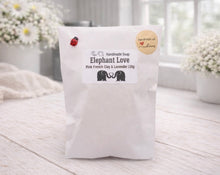 Load image into Gallery viewer, Handmade soap package with 'Elephant Love' branding on a light wooden surface.

