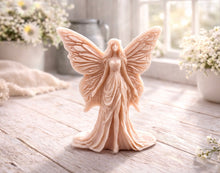 Load image into Gallery viewer, A detailed handmade vegan soap featuring an elegant fairy with large, intricate butterfly-style wings, a flowing gown, and long hair, standing against a bright farmhouse window background.
