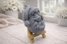 Load image into Gallery viewer, handmade vegan soap sculpted in the shape of Father Christmas's head, featuring a detailed curly beard, a jolly moustache, and a classic Santa hat, displayed on a miniature wooden easel in a bright farmhouse setting.

