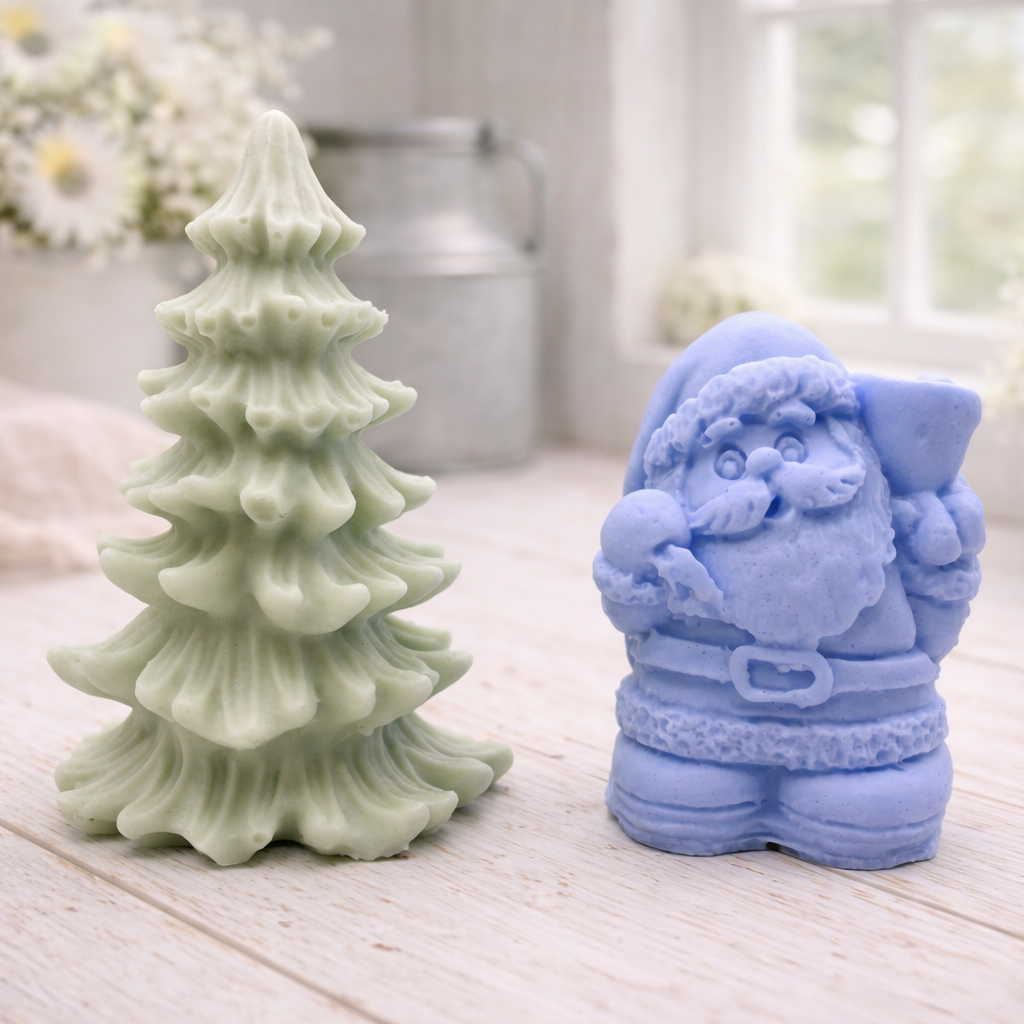 A duo of handmade vegan soaps featuring a Father Christmas figure with standing next to a mint-green tiered 3D Christmas tree, displayed in a bright farmhouse setting.