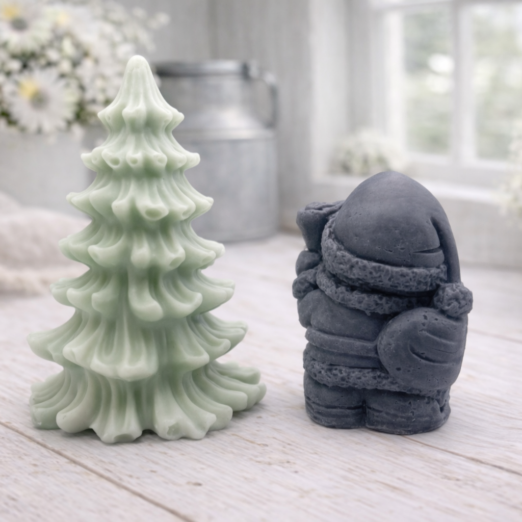 A duo of handmade vegan soaps featuring a Father Christmas figure with standing next to a mint-green tiered 3D Christmas tree, displayed in a bright farmhouse setting.