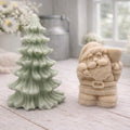 A duo of handmade vegan soaps featuring a Father Christmas figure with standing next to a mint-green tiered 3D Christmas tree, displayed in a bright farmhouse setting.