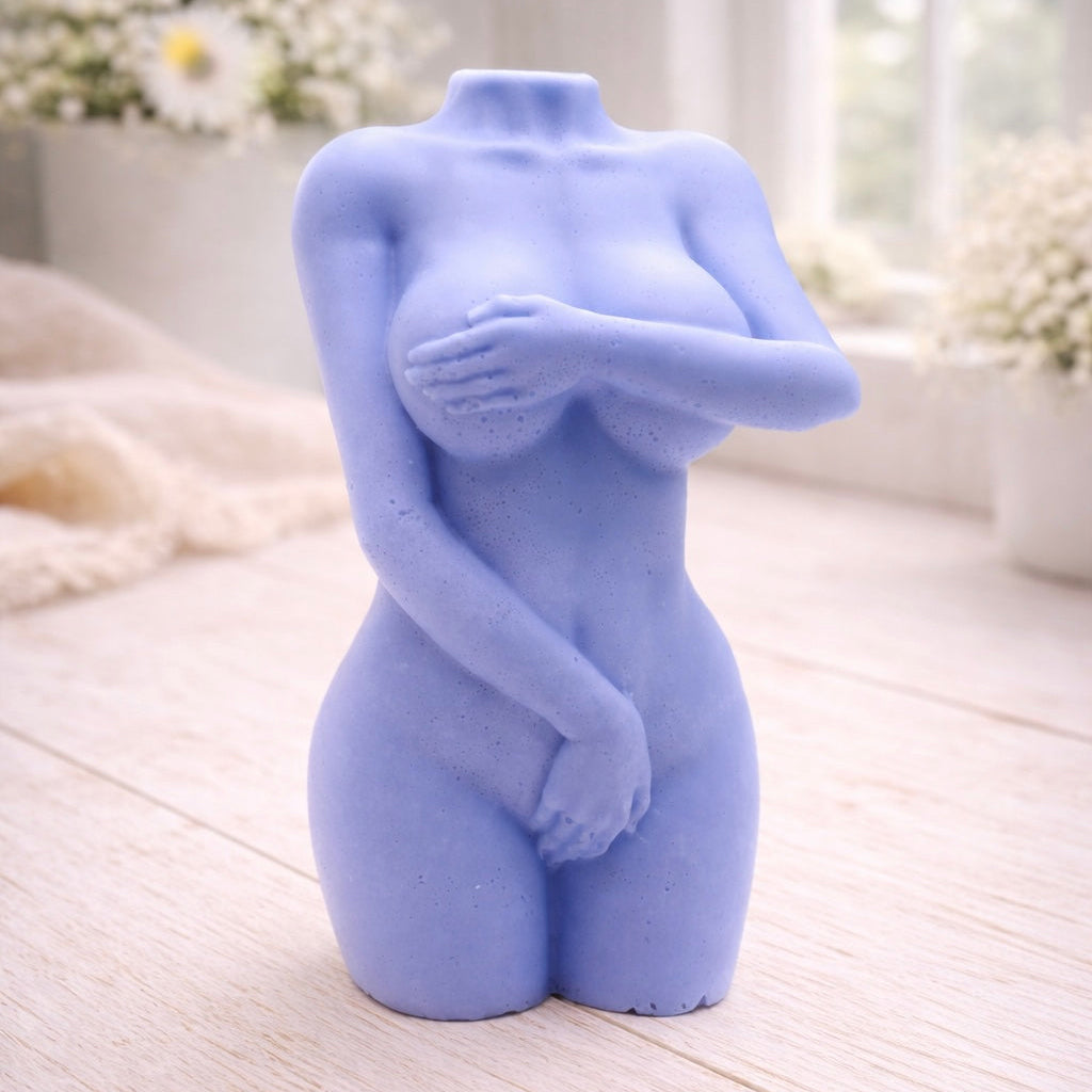 A 3D handmade vegan soap sculpted into a detailed female torso with soft, realistic curves and defined musculature and displayed in a bright farmhouse setting.