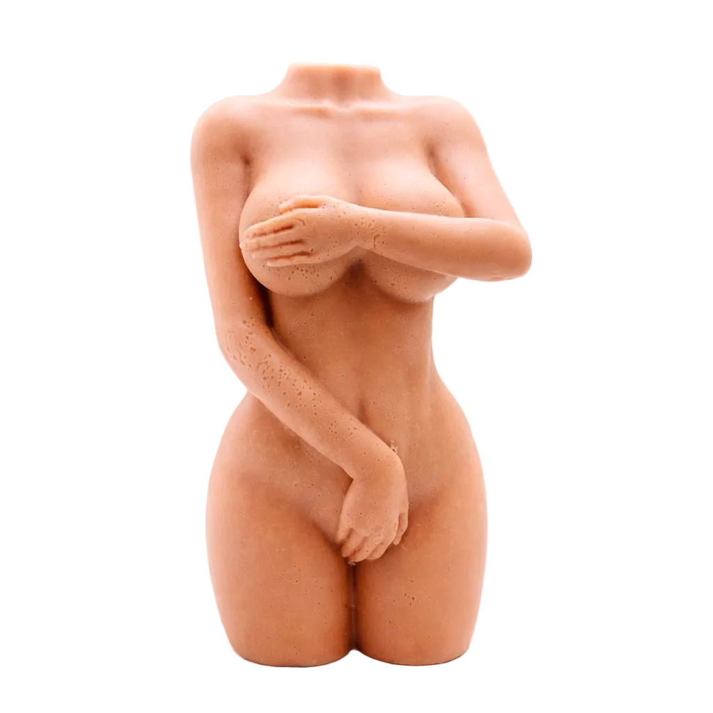 A 3D handmade vegan soap sculpted into a detailed female torso with soft, realistic curves and defined musculature and displayed in a bright farmhouse setting.