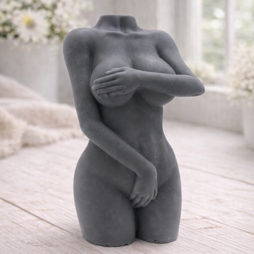 A 3D handmade vegan soap sculpted into a detailed female torso with soft, realistic curves and defined musculature and displayed in a bright farmhouse setting.