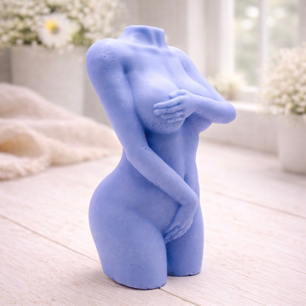 A 3D handmade vegan soap sculpted into a detailed female torso with soft, realistic curves and defined musculature and displayed in a bright farmhouse setting.