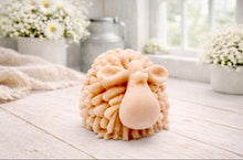 Load image into Gallery viewer, A highly detailed handmade vegan soap sculpted in the shape of a fluffy sheep with thick, textured wool and a smooth face, displayed on a light wooden surface in a farmhouse-style setting.
