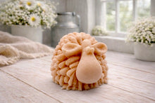 Load image into Gallery viewer, A highly detailed handmade vegan soap sculpted in the shape of a fluffy sheep with thick, textured wool and a smooth face, displayed on a light wooden surface in a farmhouse-style setting.
