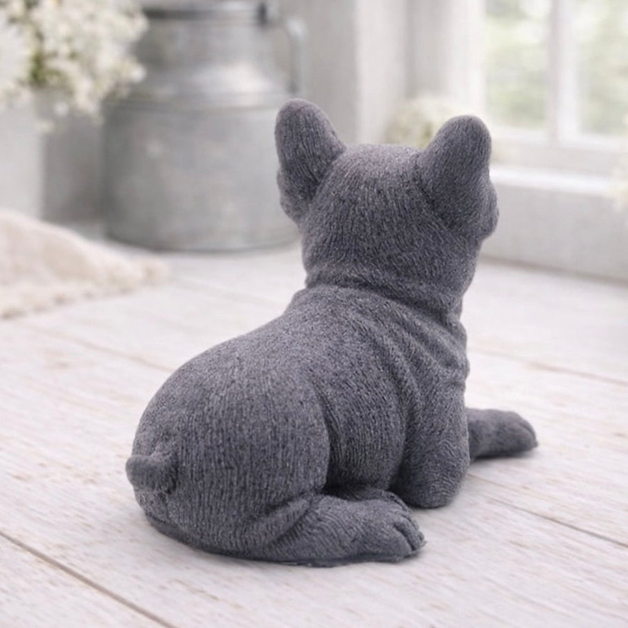 A highly detailed handmade vegan soap in a sophisticated slate-grey tone, sculpted in the shape of a French bulldog puppy sitting upright with its characteristic large ears and wrinkled face, displayed on a light wooden surface.