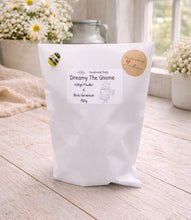 Load image into Gallery viewer, White bag of handmade soap labeled 'Dreamy The Gnome' on a wooden surface with flowers in the background.
