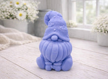 Load image into Gallery viewer, A handmade vegan soap in a natural tone, sculpted as a gnome (gonk) with a tall, curved hat that covers the eyes and has clouds on it, a round nose, and a long, textured beard.
