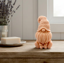 Load image into Gallery viewer, A handmade vegan soap in a natural tone, sculpted as a gnome (gonk) with a tall, curved hat that covers the eyes and has clouds on it, a round nose, and a long, textured beard.
