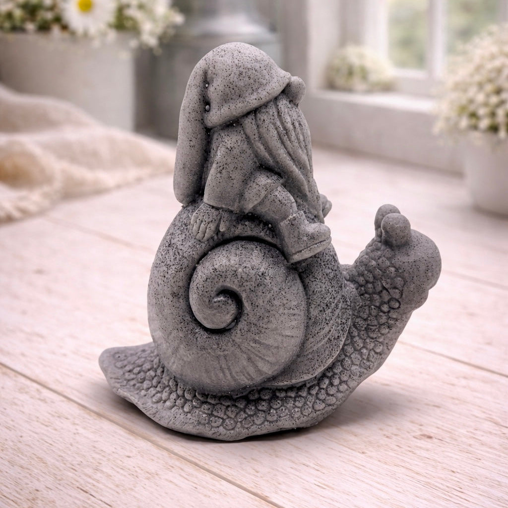 A handmade vegan soap gift, sculpted as a whimsical gnome (gonk) with a tall, slouchy hat and a long beard, sitting on the shell of a large snail with a textured, bumpy body.